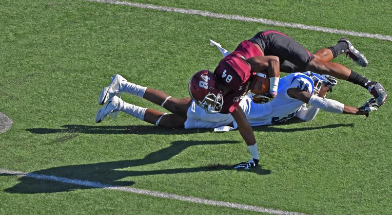 Saluki freshman wide receiver Landon Lenoir dives with the ball past Sycamore freshman defensive back Kevin Scott during SIU’s homecoming game against the Indiana State Sycamores on Saturday, Oct. 22, 2016, at Saluki Stadium. The Salukis lost with a final score of 22-14. (Anna Spoerre | @annaspoerre)