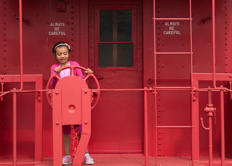 Myla Reyes, 7, of Carbondale, plays on a retired train caboose Sunday, Oct. 2, 2016, in downtown Carbondale. “I like to climb on things,” Reyes said. “It’s really fun.” She said sitting on the roofs on the train cars was her favorite part of the experience. (Jacob Wiegand | @JacobWiegand_DE)
