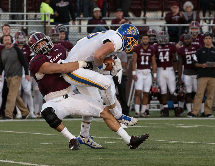Saluki senior inside linebacker Chase Allen tackles Jackrabbit junior tight end Dallas Goedert during the first half of the SIUs 45-39 loss to South Dakota State on Saturday, Oct. 8, 2016, at Saluki Stadium. (Jacob Wiegand | @JacobWiegand_DE)