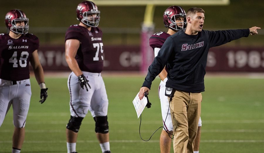 Saluki football coach Nick Hill confronts a referee during the Salukis 45-39 loss to South Dakota State at Saluki Stadium while junior offensive lineman Austin Olsen looks on.