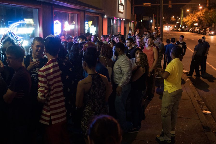Partygoers line the sidewalk as they wait to get into Stix Bar & Billiards during Unofficial Halloween early Sunday, Oct. 16, 2016, on the Strip in Carbondale. (Jacob Wiegand | @JacobWiegand_DE)