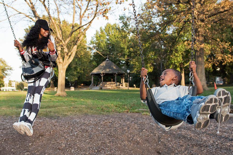 Alicia Hammond, a junior from Kankakee studying healthcare management, swings beside her son, Ryan Simington Jr., 4, on Monday, Oct. 17, 2016, at Lenus Turley Park in Carbondale. Hammond, a single mother and a full-time SIU student, recently started her own clothing line called Secrets. I keep it on the cheaper side, she said of her products, which she sells for less than $20. I dont want to break anyones pockets more than the school does. At night, after her son goes to bed, Hammond also works at NeuroRestorative in Carbondale. I had a child in high school, Hammond said. A lot of people probably doubted me and thought I wasnt going to do anything, but I never let that get in the way. (Anna Spoerre | @annaspoerre) 