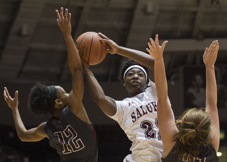 Freshman forward Tiajaney Hawkins (22) puts up a shot over William Woods freshman guard Kaycee Gerald (12) and senior forward Kelsey Scherder (21) during the Salukis 78-58 win over the William Woods Owls on Thursday, Oct. 27, 2016, at the SIU Arena. (Ryan Michalesko | @photosbylesko)