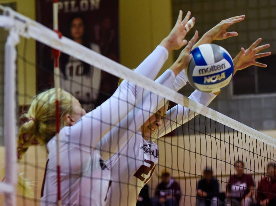 Junior outside hitter Nellie Fredriksson, left, and junior middle hitter Alex Rosignol go for a block during Loyolas 3-1 victory against the Salukis on Friday, Oct. 28, 2016, in Davies Gym. (Sean Carley | @SCarleyDE) 