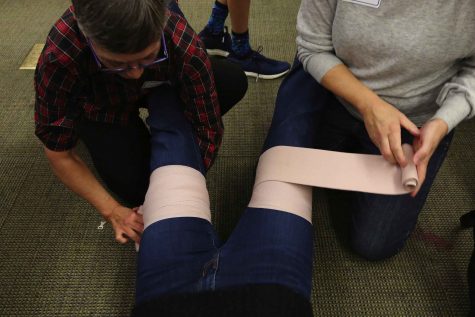 Students in Stop the Bleed learn to apply pressure to stop bleeding. "Somebody can bleed to death in three to four minutes," said Dr. Eileen Bulger. (Alan Berner/Seattle Times/TNS)