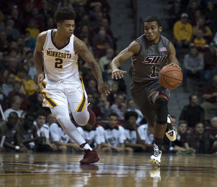 Senior guard Mike Rodriguez charges down the court alongside Minnesota junior guard Nate Mason on Friday, Nov. 25, 2016, during the Salukis 57-45 loss to the University of Minnesota at Williams Arena in Minneapolis. (Athena Chrysanthou | @Chrysant1Athena) 