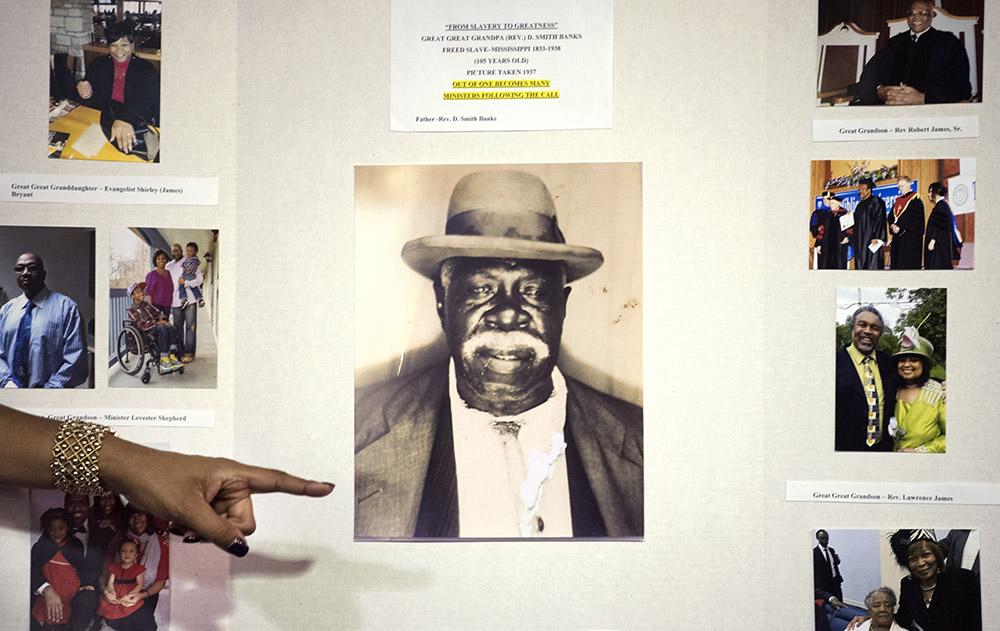 Elder Marilyn James, of Carbondale, gestures to a 1937 image of her great-great-grandfather, Rev. D. Smith Banks, during her "From Slavery to Greatness" speech Saturday, Nov. 5, 2016, at the African American Museum in the University Mall. (Morgan Timms | @Morgan_Timms)