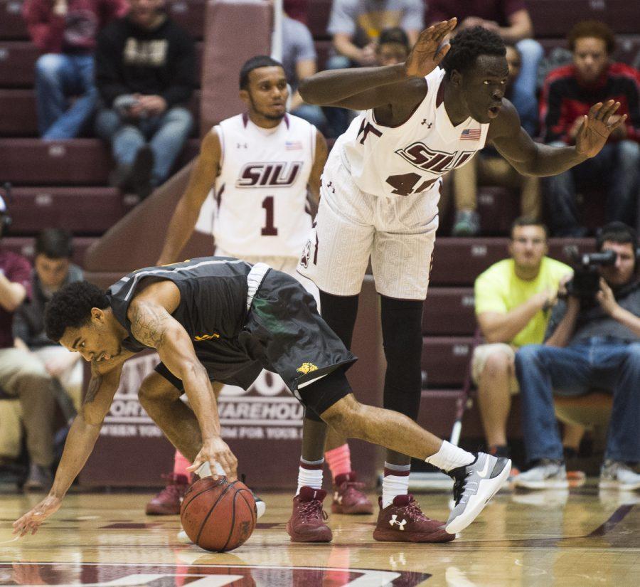Junior forward Thik Bol (40) holds himself back from fouling as Missouri Southern junior guard CJ Carr (0) attempts to recover a loose ball Wednesday, Nov. 16, 2016, during the Salukis 85-64 win over the Missouri Southern Lions at SIU Arena. (Ryan Michalesko | @photosbylesko)