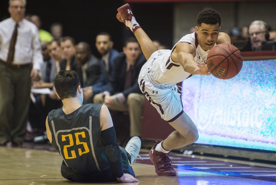Junior guard Jonathan Wiley reaches to recover a loose ball over Missouri Southern junior guard Vince Fritz (25) on Wednesday, Nov. 16, 2016, during the Salukis 85-64 win over the Missouri Southern Lions at SIU Arena. (Ryan Michalesko | @photosbylesko)  
