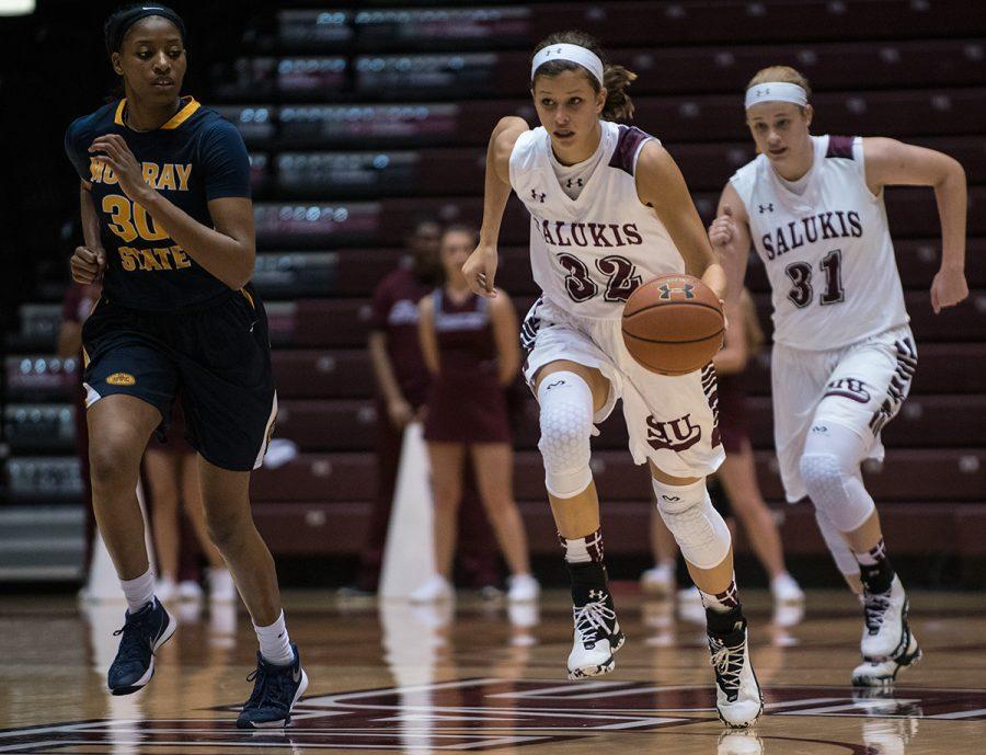 Saluki junior guard Kylie Giebelhausen (32) goes toward the goal as Racer senior forward/center Kyra Gulledge looks to make a move during SIUs 70-63 win against Murray State on Thursday, Nov. 17, 2016, at SIU Arena. (Jacob Wiegand | @jawiegandphoto)