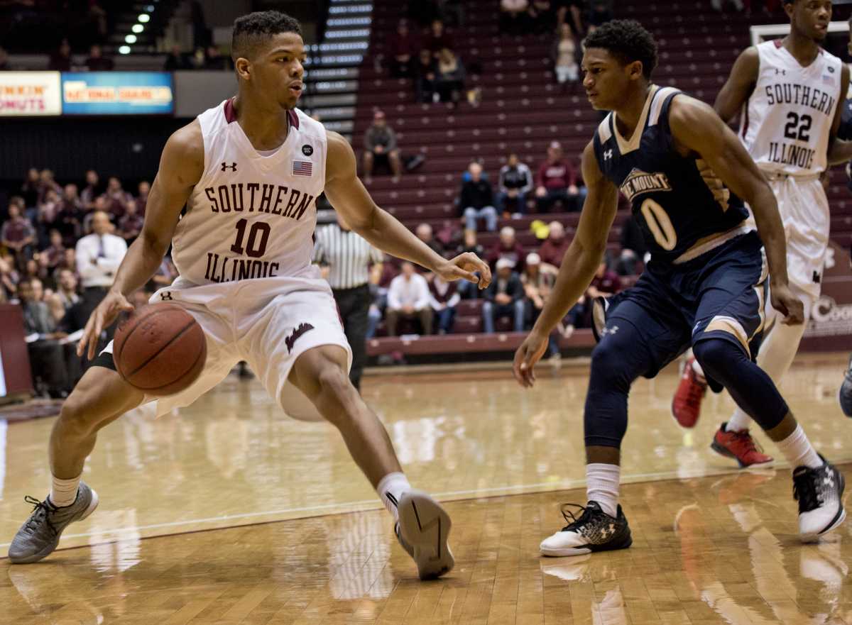 Freshman guard Aaron Cook (10) looks to make a pass past Mount St. Mary junior guard Junior Robinson (0) during the Salukis' 73-63 win over Mount St. Mary University on Monday, Nov. 21, 2016, at SIU Arena. (Athena Chrysanthou | @Chrysant1Athena)