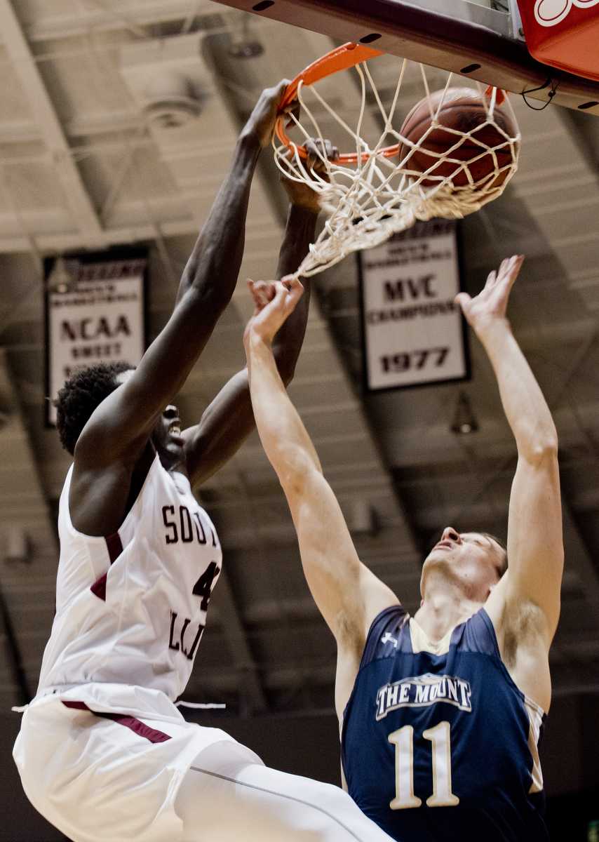 Junior forward Thik Bol dunks a shot over Mount St. Mary senior forward Will Miller (11) during the Salukis' 73-63 win over Mount St. Mary University on Monday, Nov. 21, 2016, at SIU Arena. (Athena Chrysanthou | @Chrysant1Athena)