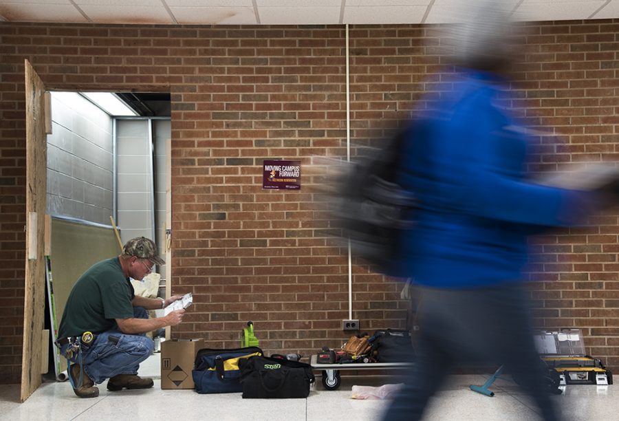 Construction worker Tom Clark, of Carterville, reads notes Tuesday, Nov. 29, 2016, while remodeling the plumbing and lights in the new gender-neutral bathrooms in Trueblood Hall.  (Morgan Timms | @morgan_timms)