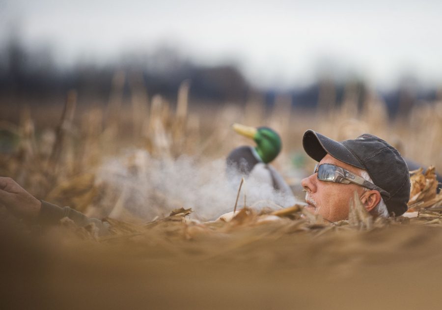Grassy Lake Hunting Club guide Duane Smith smokes a cigarette while watching for incoming ducks Wednesday, Nov. 30, 2016, during a Wounded Warriors duck hunt in Jonesboro. (Ryan Michalesko | @photosbylesko)