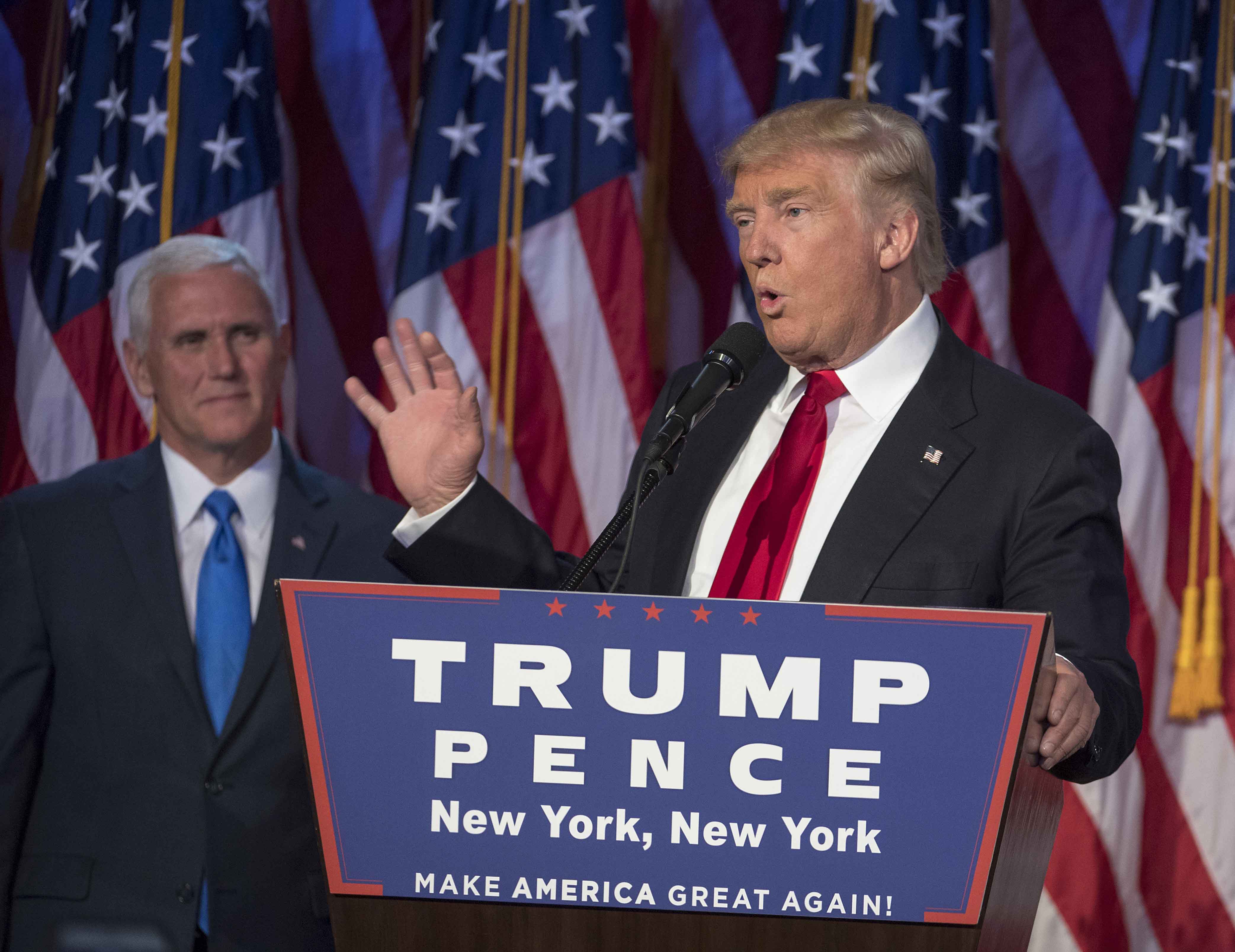 President-elect Donald Trump, joined on stage by running mate Mike Pence, speaks to supporters at the Election Night Party at the Hilton Midtown Hotel in New York City on Wednesday, Nov. 9, 2016. (J. Conrad Williams Jr./Newsday/TNS)