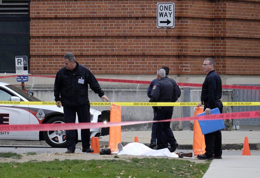 Police cover the body of a suspect along 19th Avenue outside Watts Hall on Ohio States campus following a vehicular assault and stabbing on Nov. 28, 2016 in Columbus, Ohio. (Adam Cairns/The Columbus Dispatch/TNS)
