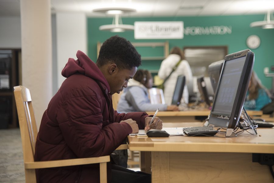 Daniel Drummer, a sophomore from Chicago studying hospitality management, takes notes from a hospitality course textbook Friday, Dec. 9, 2016 in Morris Library. “I’m trying to get in some studying,” he said. “I’ve got a final in this class in twenty minutes.”
