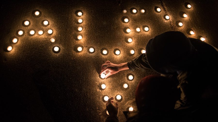 Benjamin Puffer, hand on candle, and Josh Schenkenfelder, a senior from Oak Forest studying journalism, work to craft a display of candles that reads Alex K in memory of Alex Kierstead — who died in a house fire the day before Thanksgiving — on Friday, Dec. 2, 2016, outside the burnt home in Carbondale. Puffer, a freshman from Carbondale studying physics, met Kierstead through a mutual friend. He was a really good guy, Puffer said. Hes just really cool. He had a really good soul. Its one of the best things. Kierstead, a junior from Aurora studying political science and journalism, was remembered by a few dozen friends and mourners at the candlelight vigil held outside the burnt building at 700 W. Freeman St. where Kierstead and his three roommates resided prior to the blaze. 