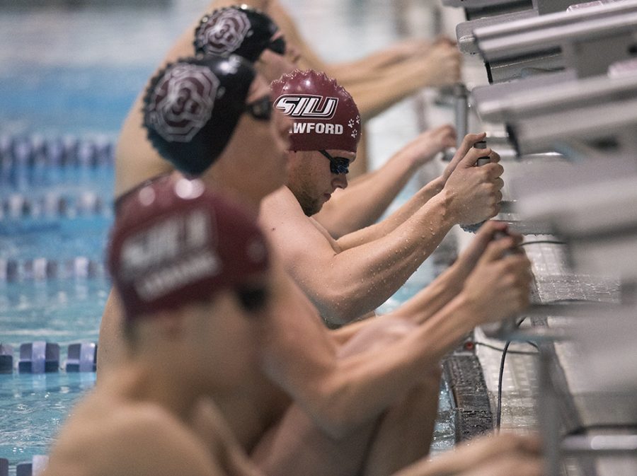 Junior Alex Crawford braces before the start of the 200-yard backstroke race Saturday, Dec. 3, 2016, during the Saluki mens teams 195-93 loss to Missouri State at Edward J. Shea Natatorium. Crawford finished in fourth place with a time of 1:53.84. (Morgan Timms | @Morgan_Timms)