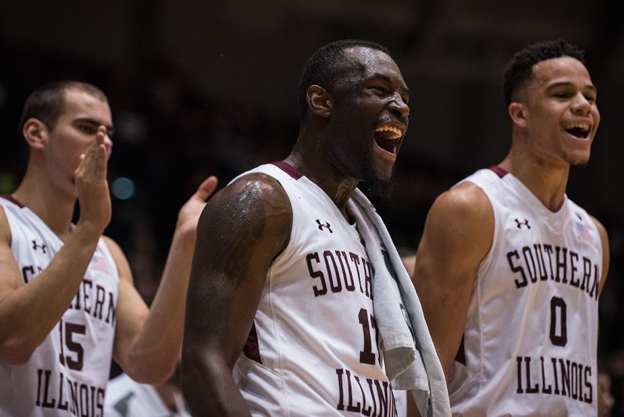 From left: sophomore forward Austin Weiher, sophomore guard Sean Lloyd and junior guard Jonathan Wiley react to a play near the conclusion of SIUs 78-70 victory against UT-Martin on Thursday, Dec. 22, 2016, at SIU Arena. (Jacob Wiegand | @jawiegandphoto)