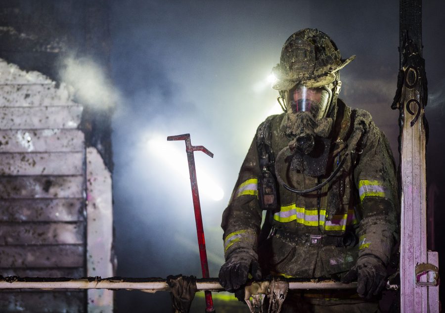A firefighter works to battle a residential structure fire in the 400 block of East James and Thelma Walker Avenue on Wednesday, Jan. 4, 2017, in Carbondale. There were no injuries, but the home is considered a total loss, Assistant Fire Chief Steve McBride said. The cause of the fire is still under investigation. (Ryan Michalesko | @photosbylesko)