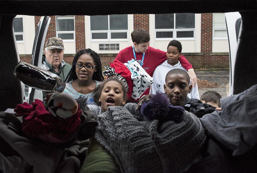 Counterclockwise from left: Good Samaritan Ministries Executive Director Mike Heath supervises Aniyah Miller, 10; Carissa Bennett, 10; Jaden Garnette-Love, 10; Darren Johnson, 10, all of Carbondale; and Zachary Myers, of Memphis, Tenn., as they fill Heath’s trunk with blankets, hats and gloves donated by the public Monday during the Boys and Girls Club of Carbondale’s Lend a Hand donation drive. The children held the drive for their annual Martin Luther King Jr. Day of Service project. The Carbondale community was invited to drop off fresh fruits and vegetables, spare change, warm blankets, hats and gloves at the Boys and Girls Club, where they were later presented to Heath and Good Samaritan vice president Maurine Pyle. “This is fantastic,” Heath said of the drive. “This is our life bread, especially at this time of year when it’s cold.” Although the state’s stopgap budget provided Good Samaritan with enough resources for 2016 and 2017, Heath said without a real budget, the organization faces financial uncertainty beyond then. “We have tremendously generous donors here in town,” Pyle said. “All of these local donors and fundraisers keep us going. It’s a community of philanthropy.”
