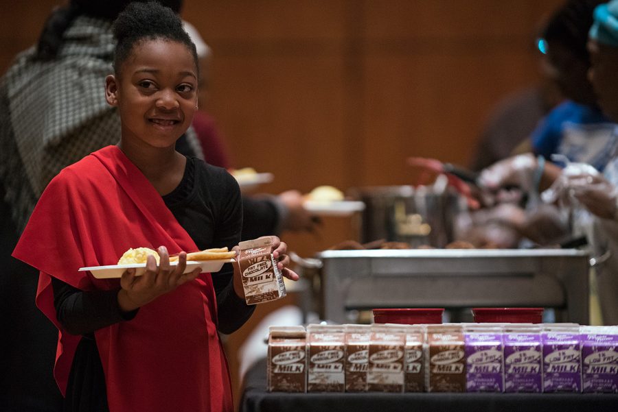 Neviah Lynon, 7, of Carbondale, cracks a smile after walking through the food line at the 35th annual King Breakfast on Monday, Jan. 16, 2017, at the Student Center. Lynon’s mother, Nelia Johnson, said they try to attend the event every year. The breakfast, which honored the life and legacy of the late civil rights advocate Martin Luther King Jr., was sponsored by the Carbondale branch of the NAACP. (Jacob Wiegand | @jawiegandphoto)