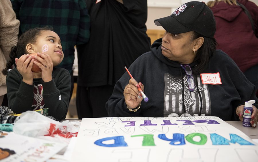 Kayelyn Jones, 4, of Carbondale, shares a moment with her grandmother, LaVell Hayes-Cox, as the pair prepare signs Saturday, Jan. 21, 2017, before the beginning of the Southern Illinois Womens March at the Carbondale Civic Center. We just want our voices to be heard, Hayes-Cox said. I want [my grandchildren] to remember that they matter. Their lives matter. Their desires in life matter. (Morgan Timms | @Morgan_Timms)