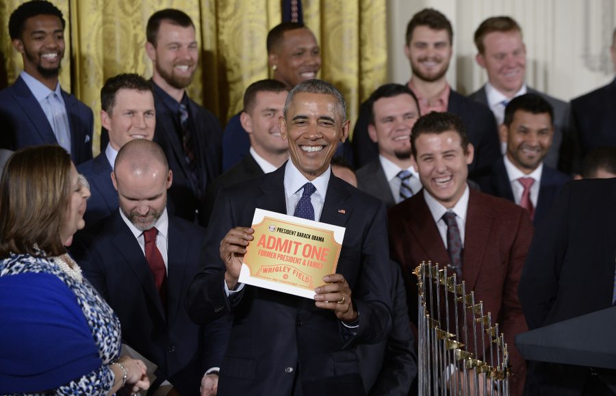 President Barack Obama receives a lifetime ticket as he welcomes the Chicago Cubs to the White House to honor the team and their 2016 World Series victory in the East Room Jan. 16 in Washington, D.C.
