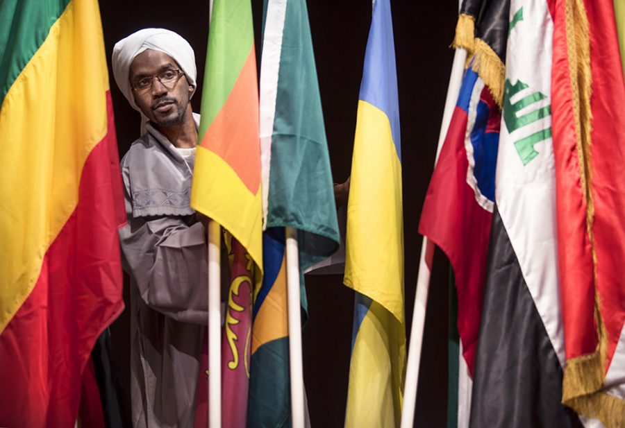 Omer Elsanusi, a Ph.D. candidate in mechanical engineering from Khartoum, Sudan, arranges flags from more than 30 different countries Monday, Feb. 6, 2017, after the annual International Parade of Flags in the Student Center ballroom. Elsanusi and his wife, Asia Abobaker, marched with their countrys flag during the parade. Sudan was one of the seven countries banned from the United States in President Donald Trumps recent executive orders. It was great to participate in this multicultural event and to be part of this community, Elsanusi said. It makes you feel like home to some extent, especially in the current circumstances. Especially when you are supported by such great people. I think thats what really matters. (Morgan Timms | @Morgan_Timms)