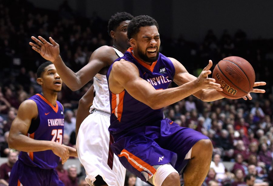 Evansville senior guard Christian Benzon reaches for the ball Saturday, Feb. 11, 2017, during the Purple Aces' 75-70 win over the Salukis at SIU Arena. (Luke Nozicka | @lukenozicka)