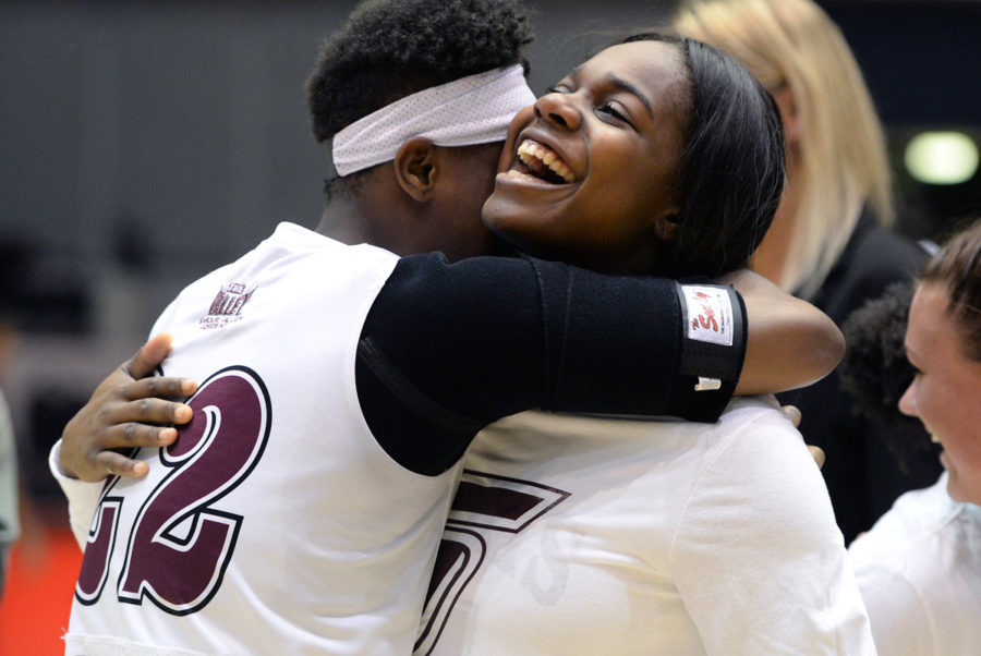 Freshman guard/forward Tiajaney Hawkins hugs senior forward Kim Nebo on Sunday, Feb. 26, 2017, after SIU’s 69-63 win over Bradley at SIU Arena. Nebo, who was recognized as one of the team's senior players after the game, scored 14 points and grabbed 10 rebounds in her last home game. (Luke Nozicka | @lukenozicka)