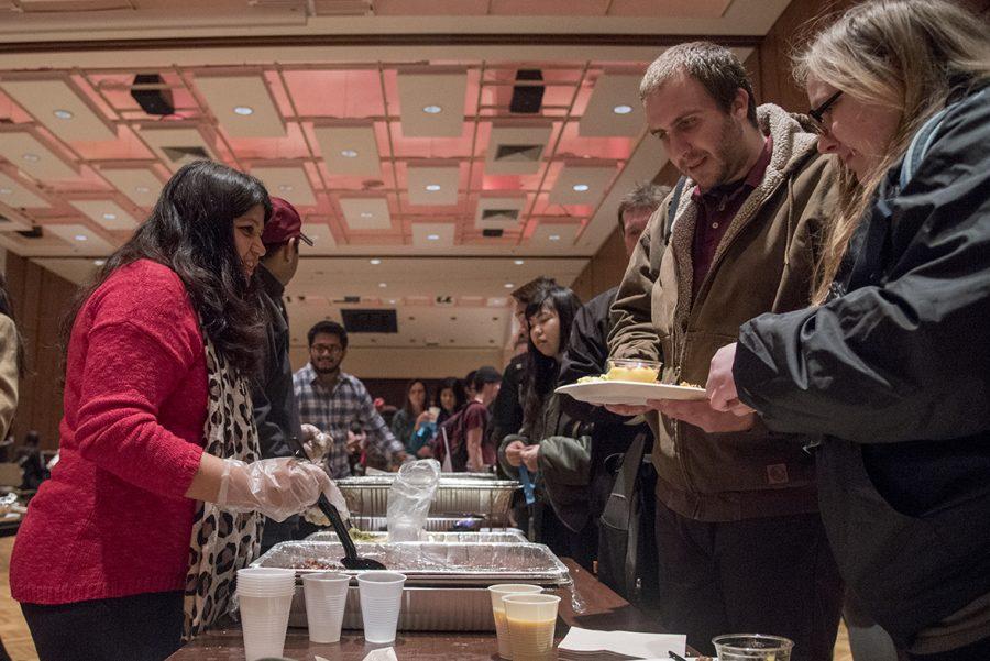 Erika Sharma, a community member working with the Nepalese Students Society, serves traditional Nepalese food Wednesday, Feb. 8, 2017, during the International Food Fair in the Student Center ballrooms. International Festival 2017 continues at 7 p.m. Friday with the Cultural Show in the Student Center ballrooms. (Branda Mitchell | @branda_mitchell)