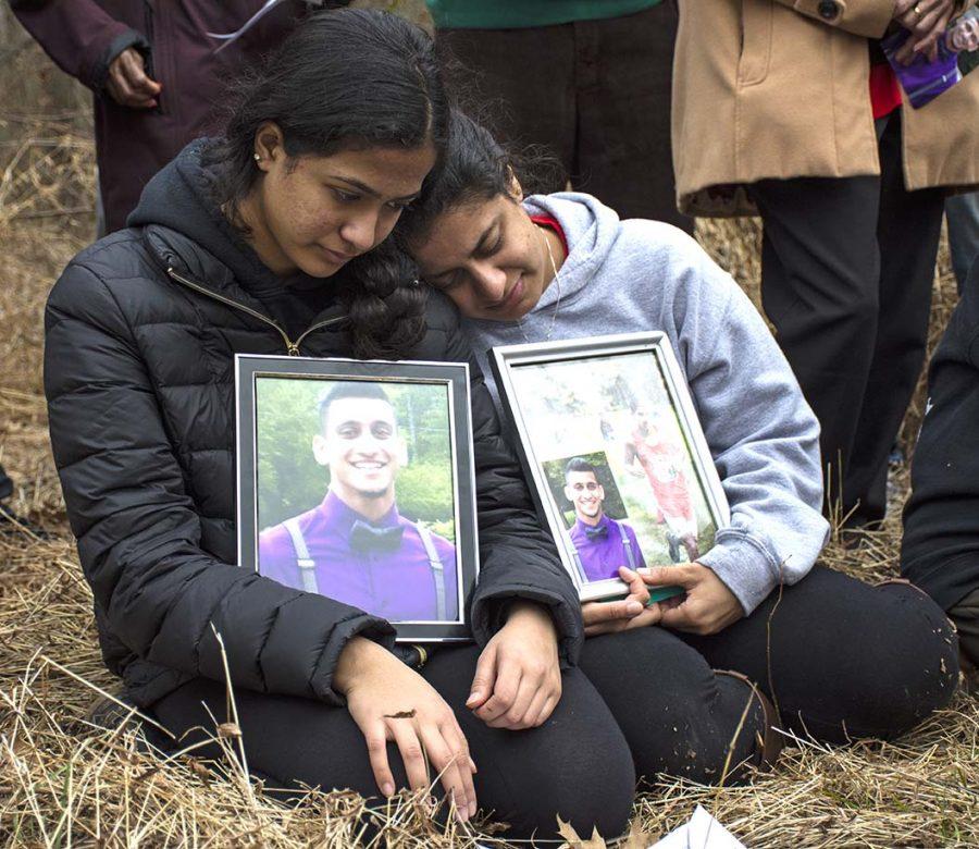 From left to right: Pravin Varughese’s younger sisters  Preethi and Priya kneel during a memorial ceremony Saturday, Feb. 11, 2017, in a wooded area bordering Illinois Route 13 where police say Pravin died of hypothermia, three years ago.Its always hard to come back here, Priya said. I still miss him a lot every day. Its nice to go back to the place where he had his last moments on earth.(Athena Chrysanthou | @Chrysant1Athena)