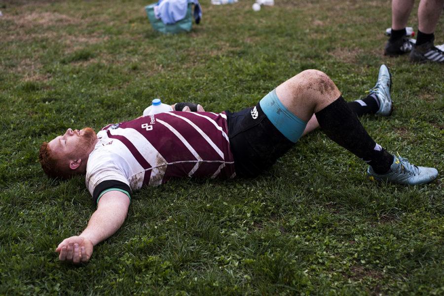 Justin Reed, of Littleton, Colorado, lies on the ground after the SIU men’s rugby 21-5 win against the Chiefs, a Chicago-based recreational team, on Saturday, March 25, 2017, at the SIU Mens Rugby 27th Anniversary All Fools Rugby Classic. (Branda Mitchell | @branda_mitchell)