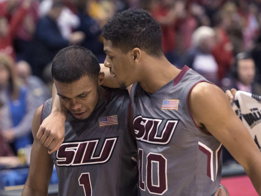 Freshman guard Aaron Cook, right, consoles senior guard Mike Rodriguez as he walks off the floor for the final time in his collegiate career Saturday, March 4, 2017, after SIU’s 63-50 loss to Illinois State in the Missouri Valley Conference men’s basketball tournament semifinals at Scottrade Center in St. Louis. (Sean Carley | @SeanMCarley)