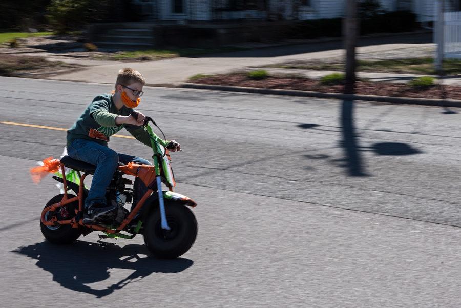Fourteen-year-old David Penrod, of Murphysboro, rides a mini bike near the end of the St. Patrick’s Day Parade on Saturday, March 18, 2017, in Murphysboro. Although Penrod has taken part in the parade in the past, this was his first year doing so while riding a mini bike. (Jacob Wiegand | @jawiegandphoto)