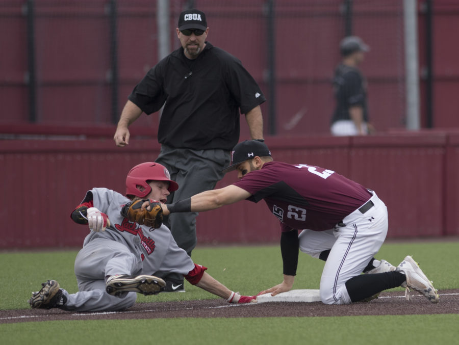 Gamecock junior infielder Taylor Hawthorne attempts to slide back to safety Friday, March 24, 2017, as Saluki senior infielder Ryan Sabo holds the ball at third base. The umpire called Hawthorne out. Jacksonville State went on to beat SIU 8-6 during the first of a three-game series at Itchy Jones Stadium. (Bill Lukitsch | @lukitsbill)