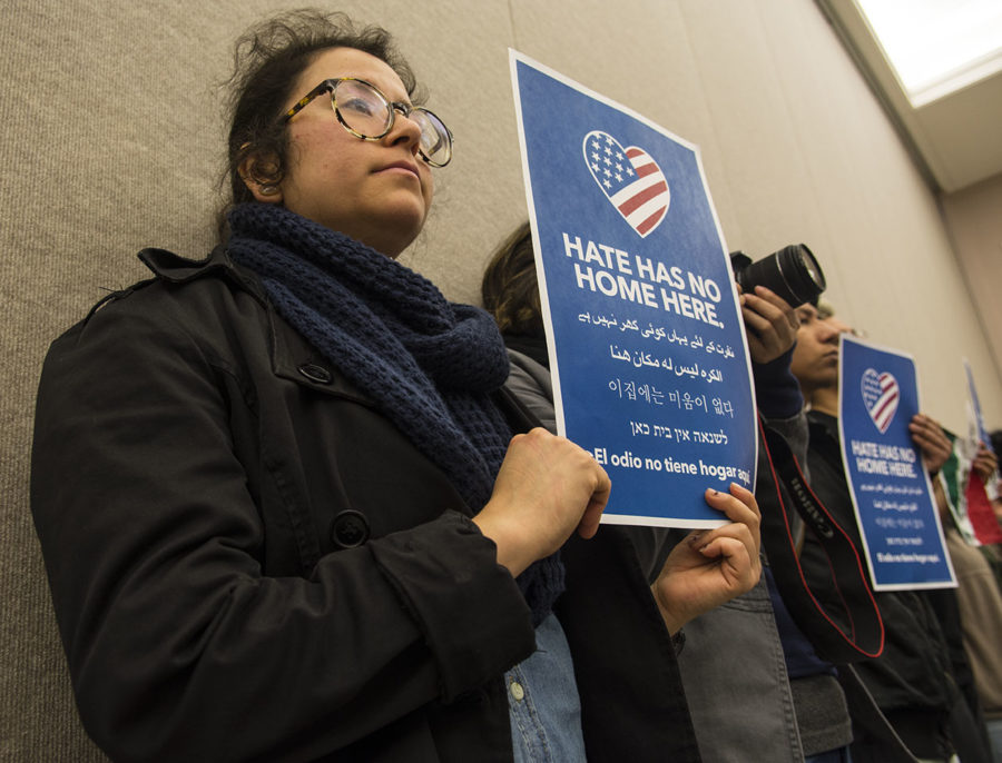 Martha Osornio, a senior from Chicago studying cinema and photography, holds a “Hate has no home here.” sign Tuesday, April 11, 2017, during a city council meeting at the Carbondale Civic Center. Osornio, whose family immigrated illegally to the United States in 1992, attended the meeting with five other students from the Hispanic Student Council to support the resolution establishing Carbondale as a safe and welcoming community. Osornio said she has friends in Chicago who fear they might be deported for insignificant issues if they enrolled at SIU. It makes them feel like they are welcomed, anyone that is undocumented, Osornio said. (Athena Chrysanthou | @Chrysant1Athena) 