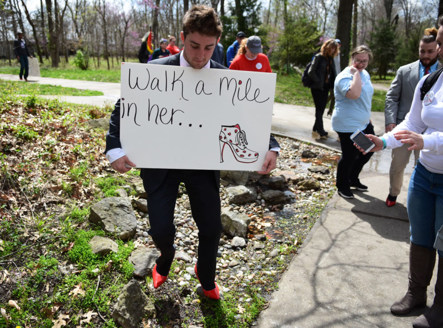 Clayton Bertoletti, a freshman from Oak Park studying accounting, walks across campus in high heels Thursday, April 6, 2017, during the Walk a Mile in Her Shoes event to encourage sexual assault awareness. (Athena Chrysanthou | @Chrysant1Athena)