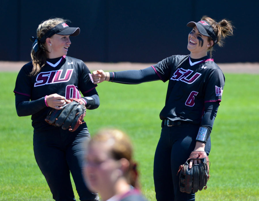 Junior third baseman Sydney Jones (left) and junior shortstop Savannah Fisher joke around before an inning during the second game of SIUs doubleheader with Wichita State on Sunday, April 23, 2017 at Charlotte West Stadium in Carbondale. The Salukis won the game 5-4. (Sean Carley | @SeanMCarley)