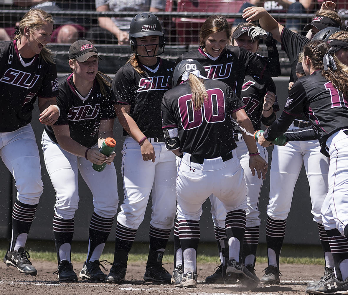 Junior catcher/infielder Sydney Jones is greeted at home plate by her teammates after hitting a 2-run homer Sunday, May 7, 2017, during the Salukis’ 3-2 win against Missouri State at Charlotte West Stadium. (William Cooley | @Wcooley1980)