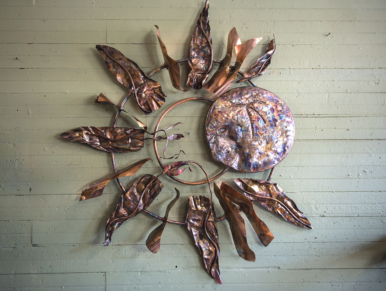 One of Dave Dardis’ eclipse metal sculptures hangs on the wall Tuesday, Aug. 8, 2017, in his studio in Makanda. (Athena Chrysanthou | @Chrysant1Athena)