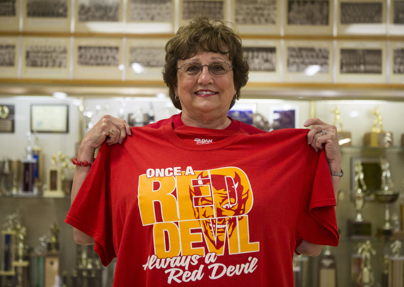 Jan Etherton, a long time superfan of the Murphysboro Red Devils shows off her t-shirt prior to the 100th meeting between the Red Devils and the Carbondale Terriers on Friday, Aug. 25, 2017, at Doc Bencini Field, in Murphysboro, Illinois. Well, I think the thing that tells my story is this, said Etherton as she lifted the shirt. This is my shirt that Im going to be buried in.  (Ryan Michalesko | @photosbylesko)