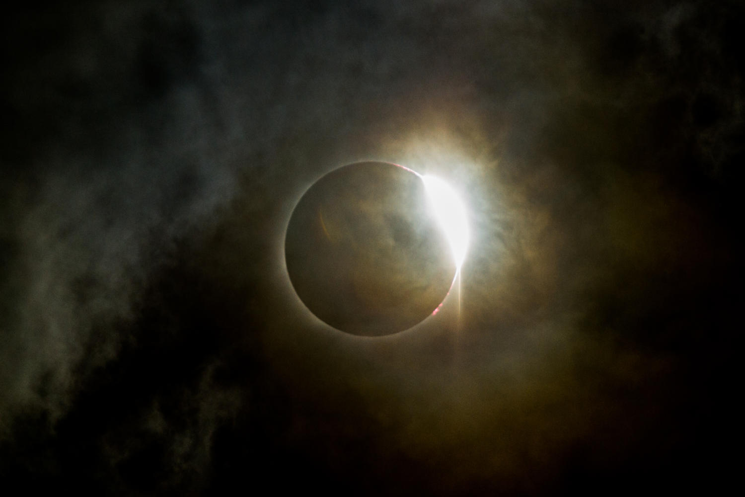 The diamond ring effect is pictured shortly after the Great American Eclipses totality, Monday Aug. 21, 2017, at Saluki Stadium. Thousands of eclipse viewers fought cloud coverage to see the eclipses totality at Saluki Stadium. (Brian Muñoz | @BrianMMunoz)