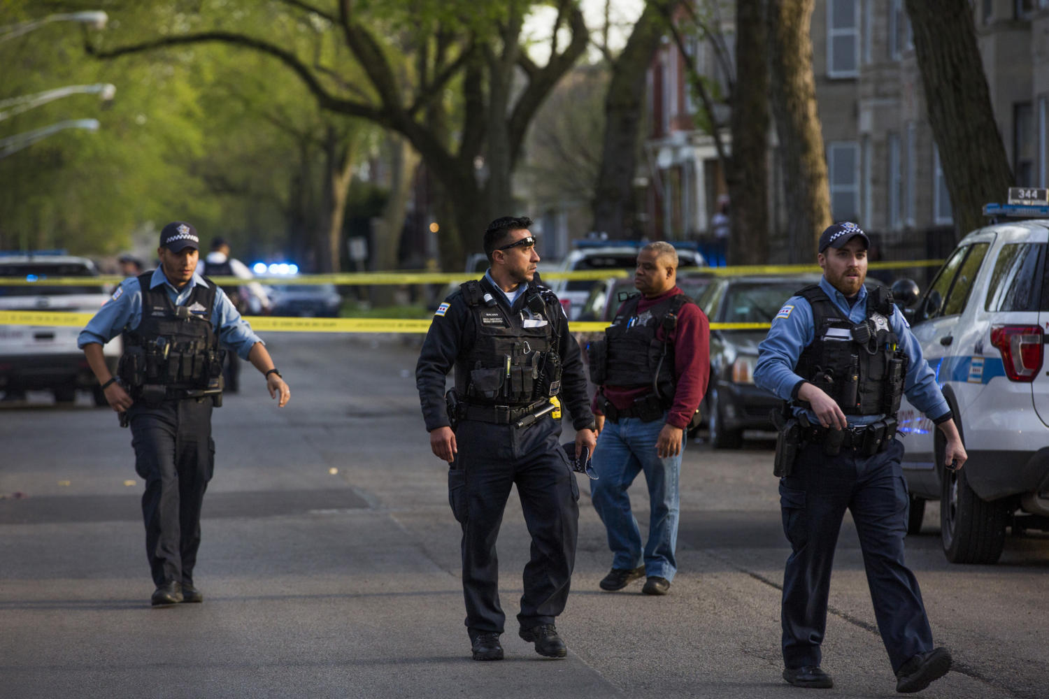 Members of the Chicago Police Department investigate the area where two people were shot in the 6400 block of South Eberhart Avenue on April 24, 2017, in Chicago, Ill. (Armando L. Sanchez/Chicago Tribune/TNS)