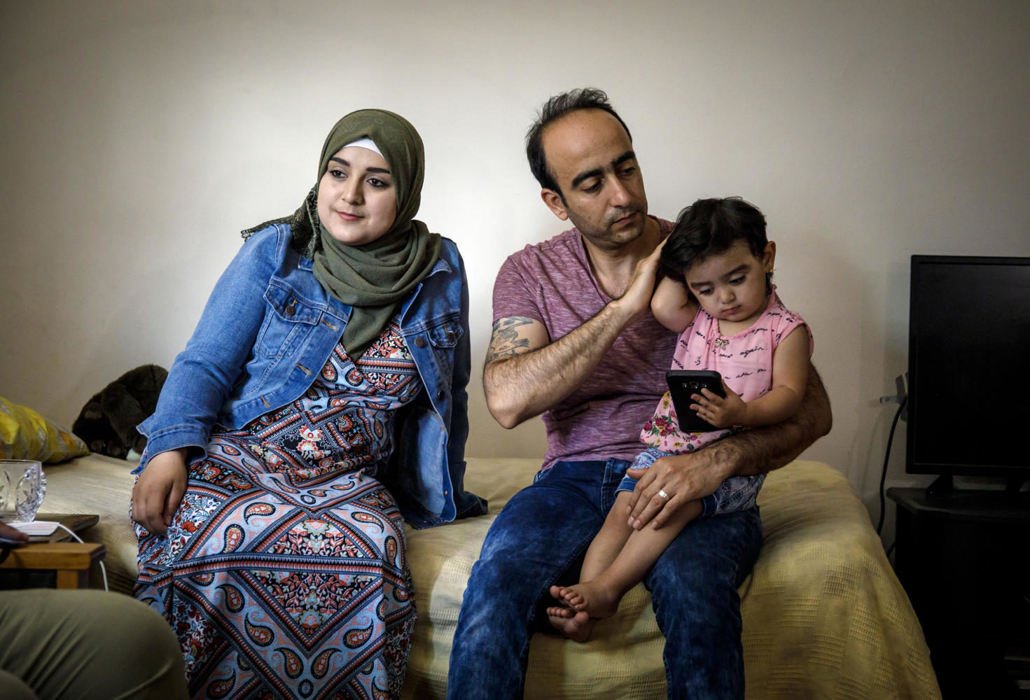 Baraa, Abdulmajeed and Sham Haj Khalaf sit in the living room of their Skokie, Ill. home on July 23, 2017. The family emigrated as refugees from Syria. (Brian Cassella/Chicago Tribune/TNS)