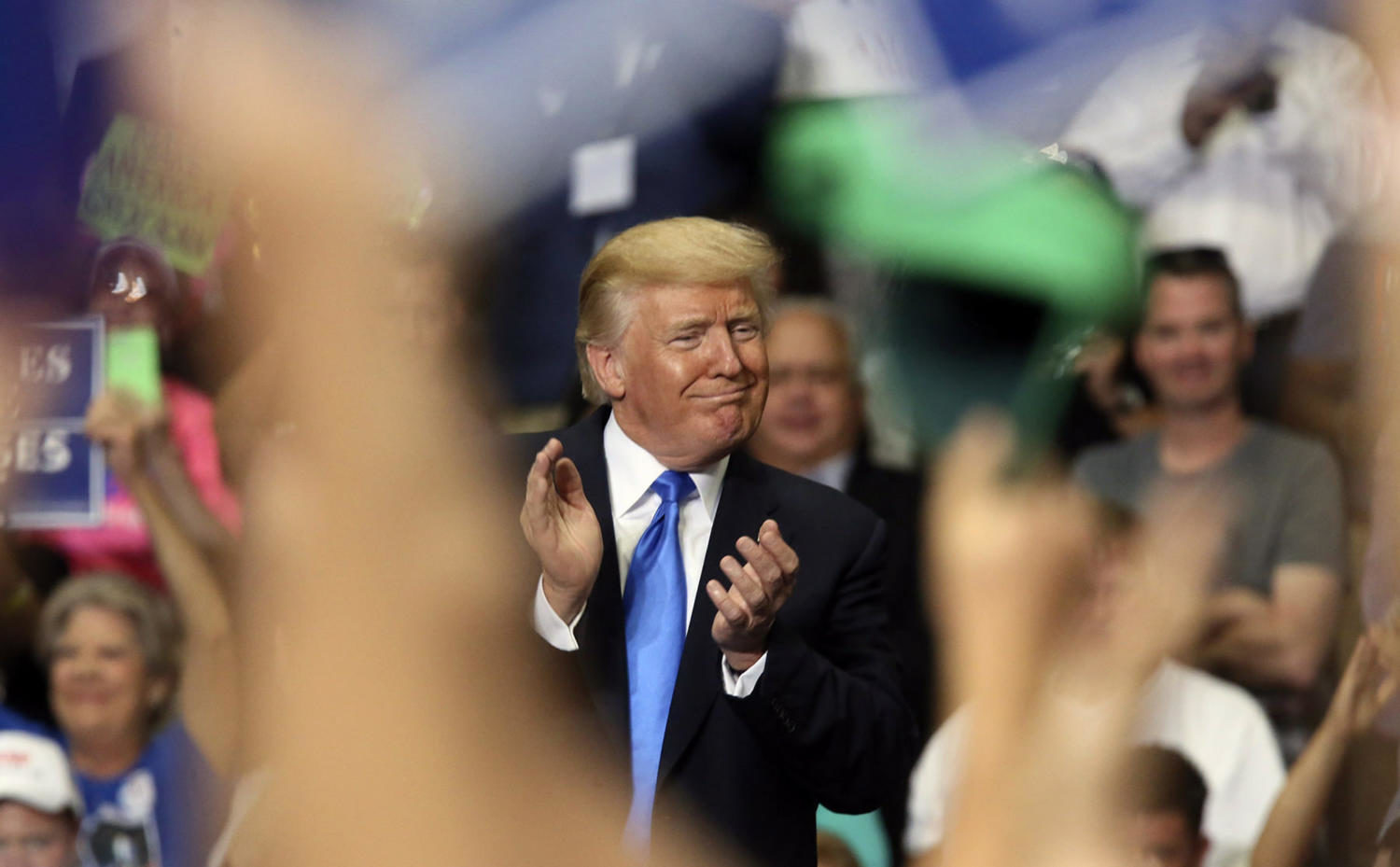 President Donald Trump joins in clapping as he basks in the applause at a Make America Great Again rally at the Covelli Centre in Youngstown, Ohio, on July 25, 2017. 