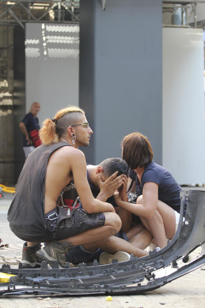 Injured people react after a van crashed into pedestrians on Thursday, Aug. 17, 2017 in Las Ramblas, downtown Barcelona, Spain. According to initial reports a van crashed into a crowd in Barcelonas famous Placa Catalunya square at Las Ramblas area. Local media report the van driver ran away, metro and train stations were closed. (David Armengou/EFE/Zuma Press/TNS)