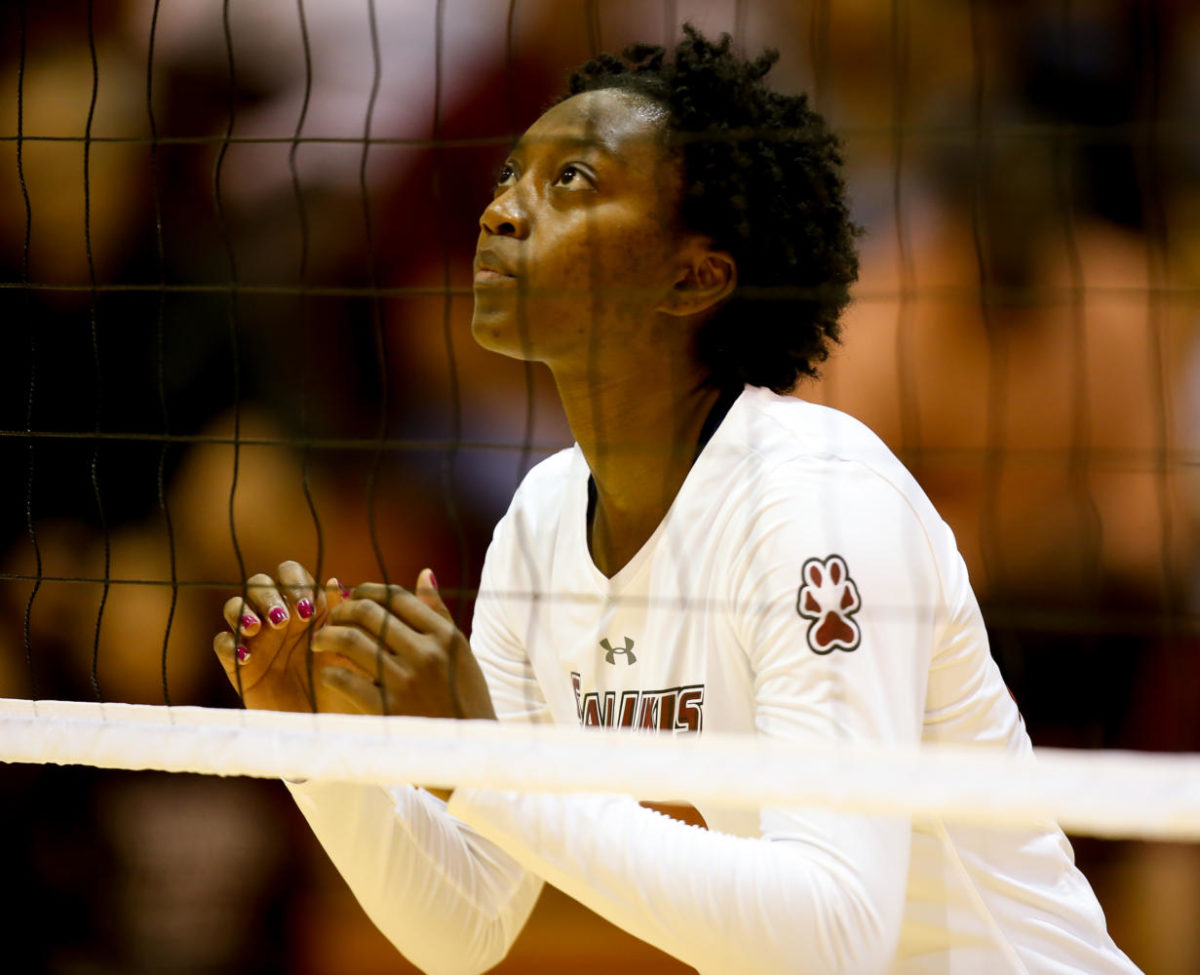 Middle blocker Patience Brown eyes the ball during the Salukis winning game against the Evansville Purple Aces Sept. 29, 2017, at Davies Gym.